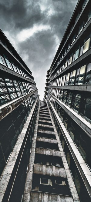 Monochrome view of modern buildings against a cloudy sky