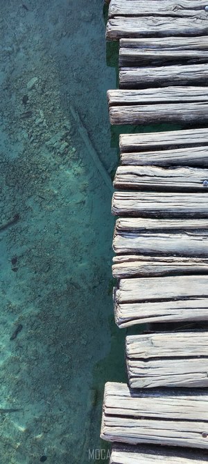 Wooden boardwalk over a clear turquoise lake