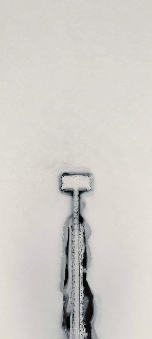 Aerial view of a snow-covered pier on a frozen body of water