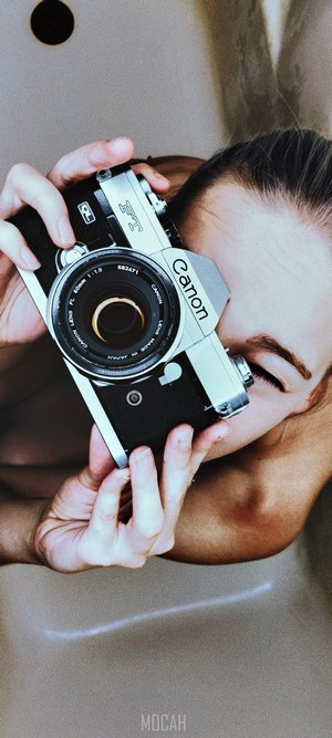Person holding a Canon FTb camera