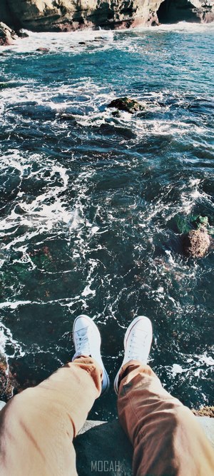 Person sitting by the ocean