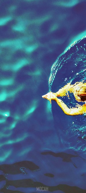 Woman swimming in blue water