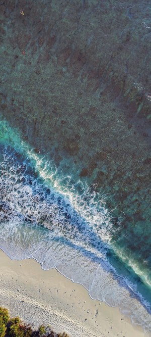 Drone aerial view of ocean waves on Maldives beach
