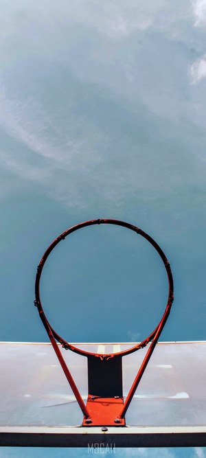 Basketball hoop against a cloudy sky
