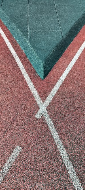 Running track with white lines and green surface