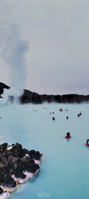 People swimming in a steamy hot spring