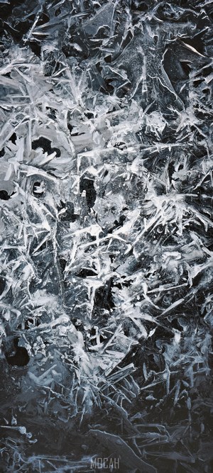 Close-up of ice formations on a dark surface