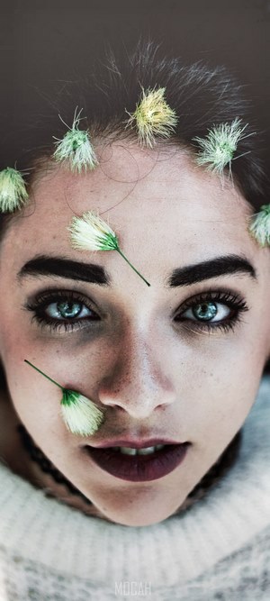 Woman with flowers on face