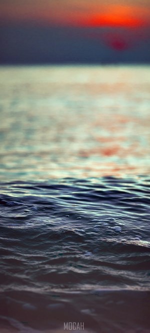 Sunset over the sea with waves