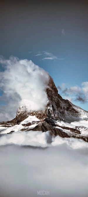 Matterhorn mountain peak covered in snow and clouds