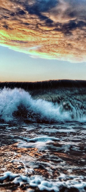 Ocean wave with dramatic clouds
