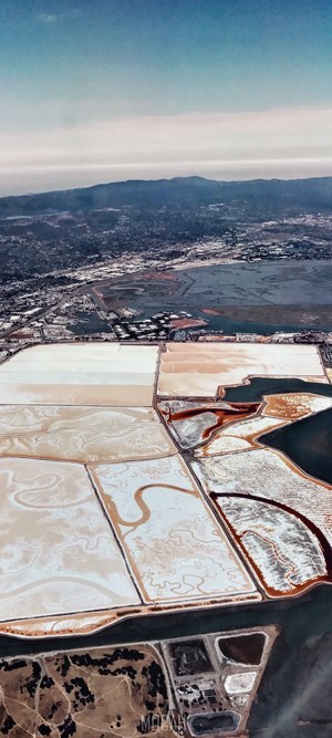 Aerial view of salt ponds and mountains