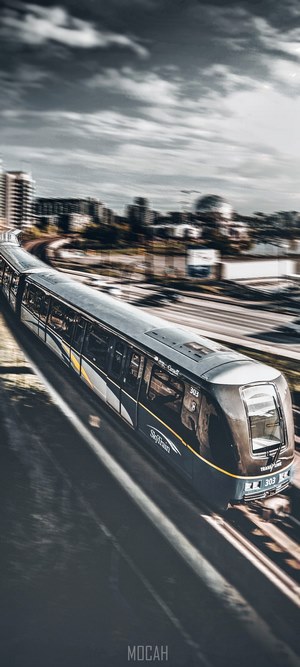 SkyTrain 303 in motion with city skyline