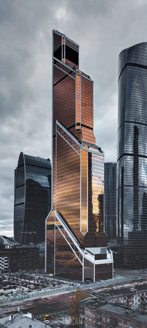 Moscow City skyscrapers under cloudy sky