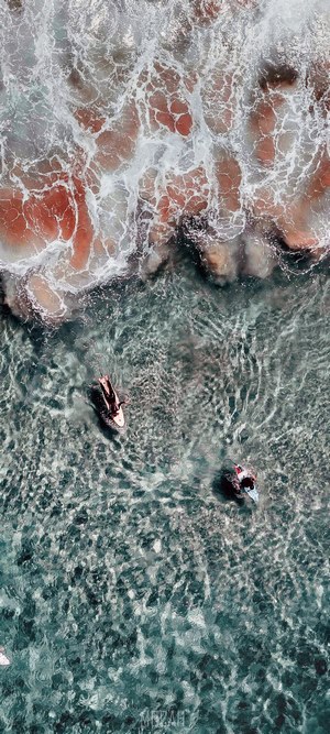 Two surfers on surfboards in the ocean