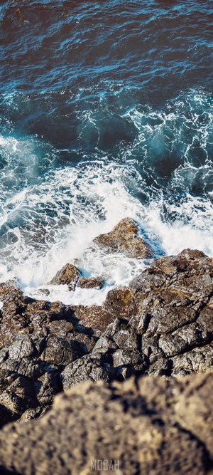 Ocean waves crashing on rocky shore