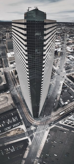Aerial view of a modern skyscraper and city streets