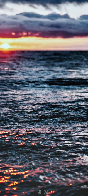 Sunset over the ocean with dramatic clouds