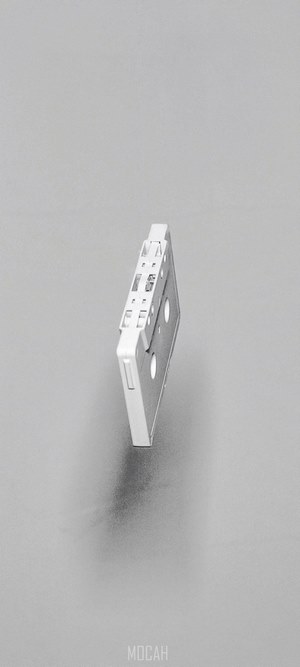 A white cassette tape suspended in the air