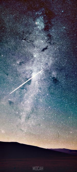 Meteor shower over a dark landscape