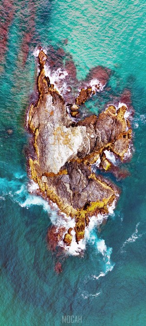Aerial view of a rocky island in turquoise water