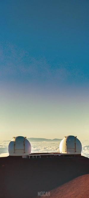 Observatory domes above clouds with blue sky