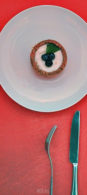 Dessert with blueberries on a white plate with cutlery