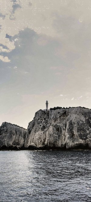 Lighthouse on a rocky cliff overlooking the sea