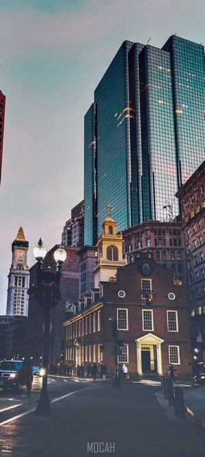 Old brick building and modern skyscrapers on a street