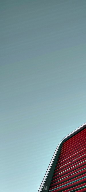 Red building facade against a clear sky