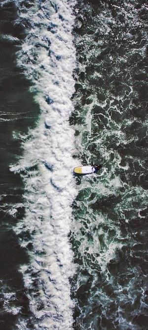 Person on a paddleboard in choppy ocean waves