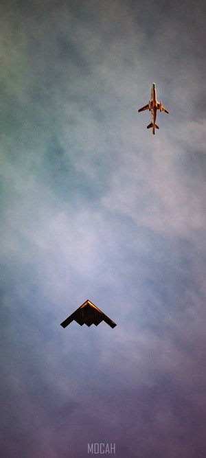 B-2 Spirit stealth bomber and airplane in the sky