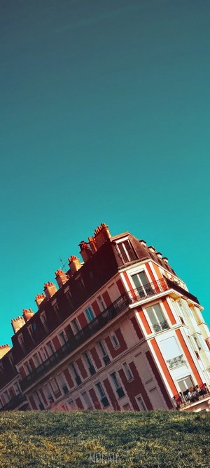 Building architecture with red and white facade under blue sky