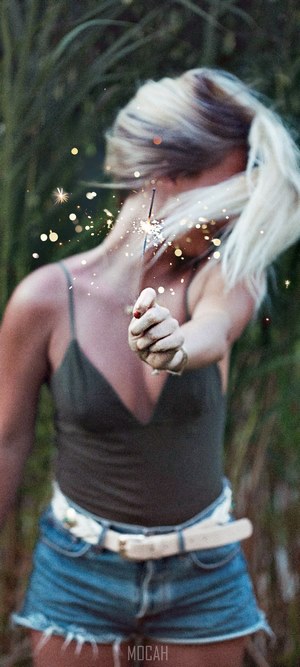 Woman holding a lit sparkler