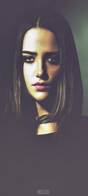 Woman with dark hair and dramatic lighting