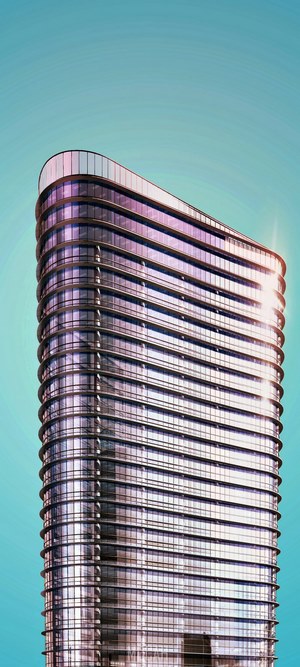 Modern skyscraper with curved glass facade against blue sky