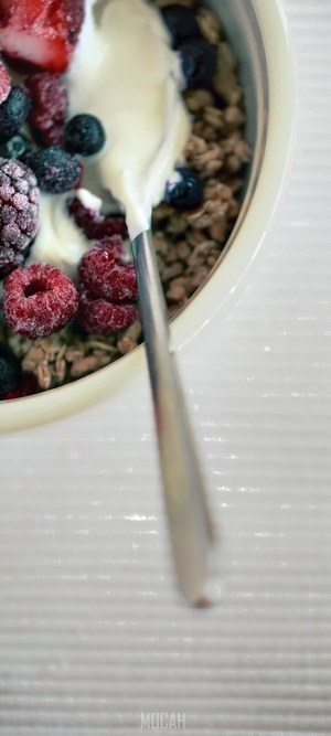 Yogurt with granola and mixed berries in a bowl