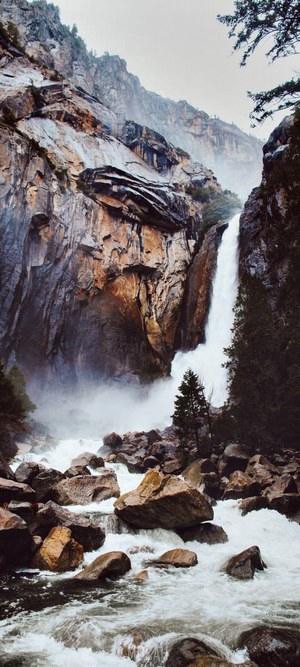 Waterfall cascading over rocky cliffs into a stream