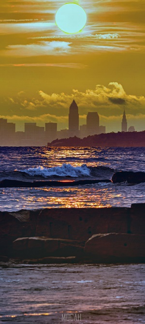 Sunset over Cleveland skyline with waves