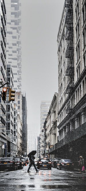 Manhattan street in the snow with a pedestrian