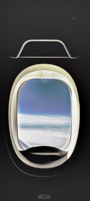 Airplane window view of clouds and sky
