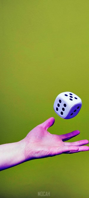 Hand tossing a white die
