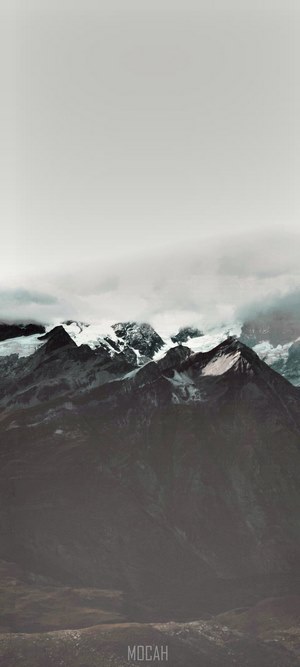 Snowy mountain peaks under clouds
