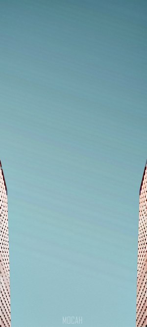 Two modern skyscrapers against a clear sky