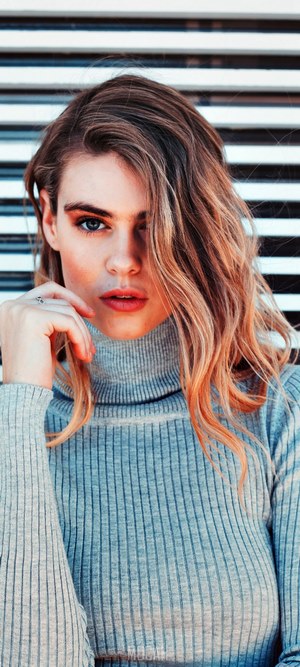 Woman in a grey turtleneck sweater