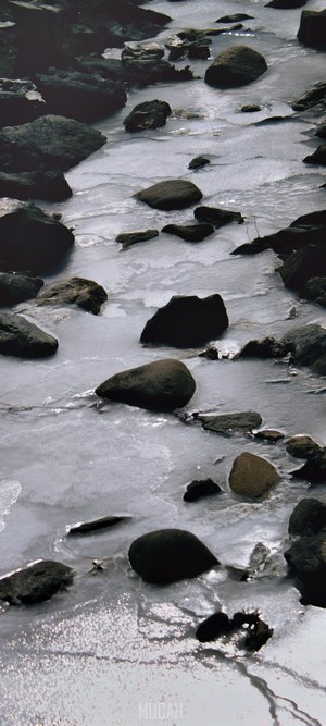 Frozen stream with rocks and ice