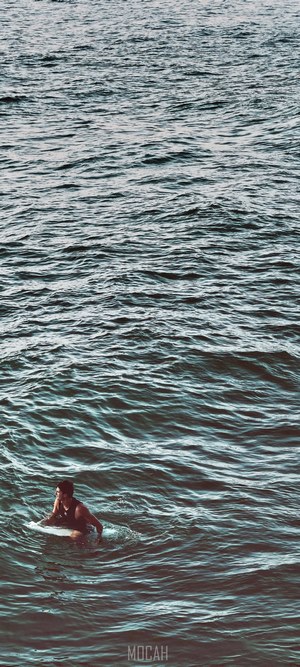 Man on surfboard in the ocean