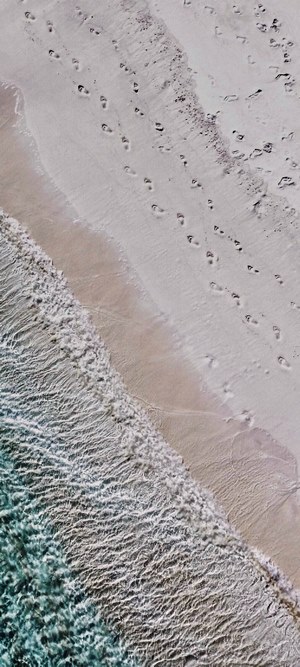Footprints on a sandy beach by the ocean