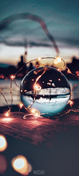 Lens ball with fairy lights and city skyline