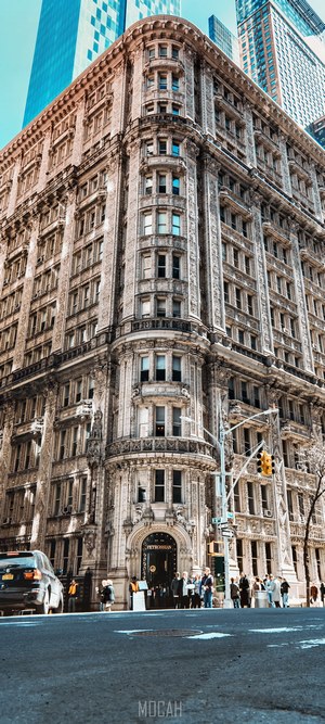 Ornate building facade with modern skyscrapers behind